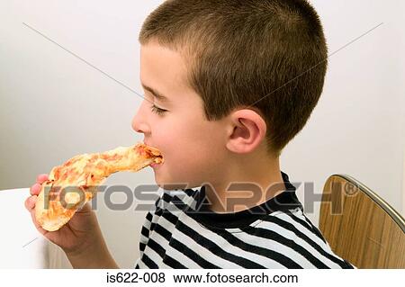 Stock Photo - Boy eating a slice of pizza. Fotosearch