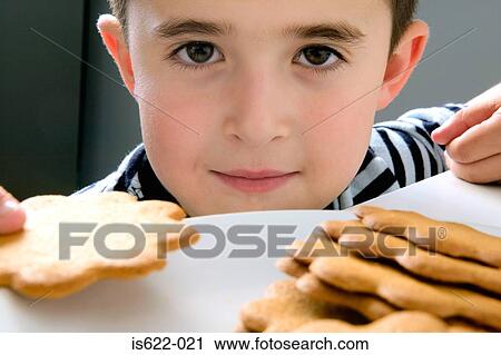 Boy holding a biscuit View Large Photo Image Stock Image - Boy holding a biscuit. Fotosearch