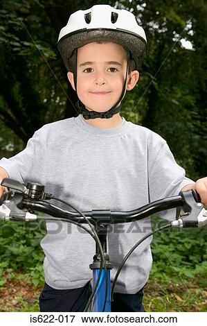 Boy wearing a bicycle helmet View Large Photo Image Stock Photo - Boy wearing a bicycle helmet. Fotosearch