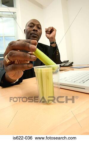 Businessman eating celery View Large Photo Image Stock Photograph - Businessman eating celery. Fotosearch