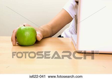 Businessman holding an apple View Large Photo Image Stock Image - Businessman holding an apple. Fotosearch