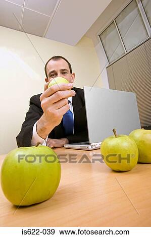 Businessman with apples on desk View Large Photo Image Stock Photo - Businessman with apples on desk. Fotosearch