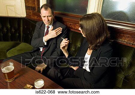 Stock Photo - Businesspeople talking in bar. Fotosearch