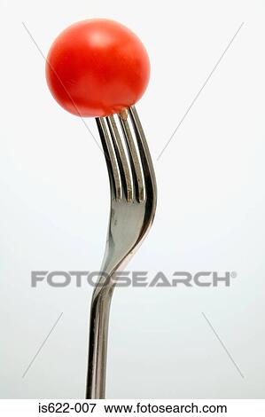 Cherry tomato on a fork View Large Photo Image Stock Photo - Cherry tomato on a fork. Fotosearch