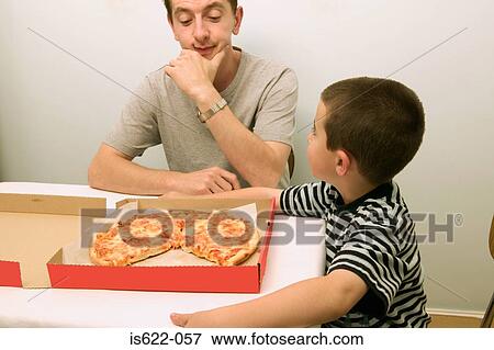 Father and son eating pizza View Large Photo Image Stock Photo - Father and son eating pizza. Fotosearch