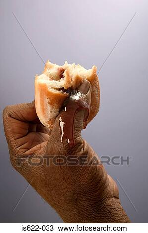 Man holding a jam doughnut View Large Photo Image Stock Image - Man holding a jam doughnut. Fotosearch
