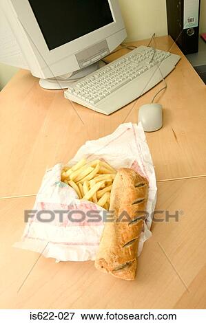 Stock Photo - Unhealthy food on desk. Fotosearch