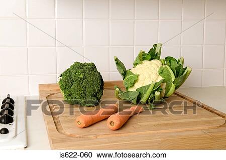 Vegetables on a cutting board View Large Photo Image Stock Image - Vegetables on a cutting board. Fotosearch