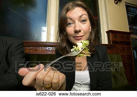 Woman eating a salad in bar View Large Photo Image Stock Photograph - Woman eating a salad in bar. Fotosearch