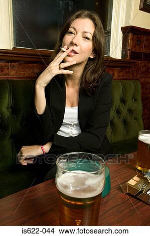 Woman smoking in a bar View Large Photo Image Picture - Woman smoking in a bar. Fotosearch