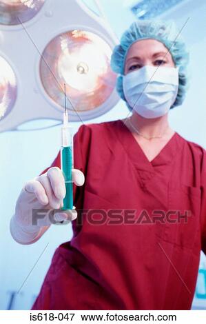 Stock Photo - Anesthetist preparing injection. Fotosearch
