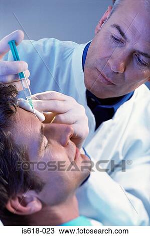 Stock Image - Man having BOTOX ® injections. Fotosearch
