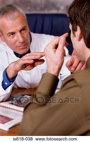 Man talking to a doctor View Large Photo Image Stock Photo - Man talking to a doctor. Fotosearch