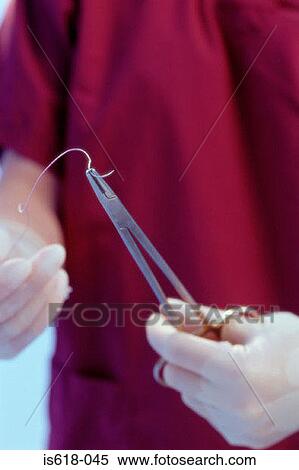 Surgeon preparing stitches View Large Photo Image Stock Photography - Surgeon preparing stitches. Fotosearch