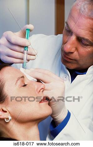 Stock Photo - Woman having BOTOX ® injections. Fotosearch