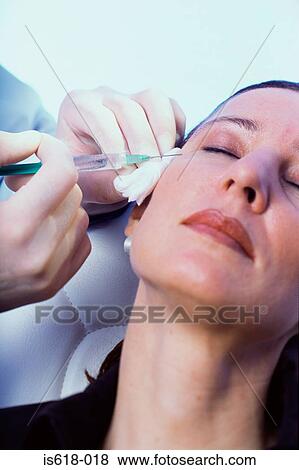Stock Photo - Woman having BOTOX ® injections. Fotosearch