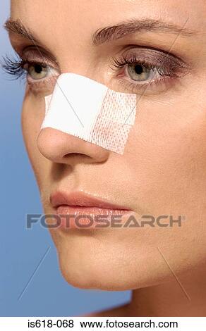 Woman wearing an adhesive plaster on face View Large Photo Image Stock Photo - Woman wearing an adhesive plaster on face. Fotosearch