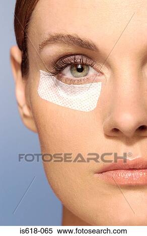 Woman wearing an adhesive plaster on face View Large Photo Image Stock Photography - Woman wearing an adhesive plaster on face. Fotosearch