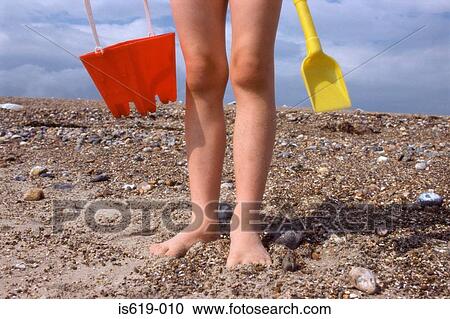 Child on beach with bucket and spade View Large Photo Image Stock Image - Child on beach with bucket and spade. Fotosearch