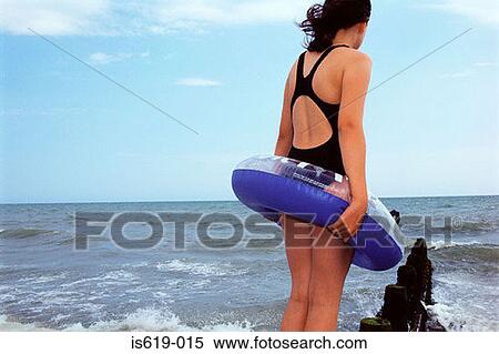 Stock Photography - Girl standing near sea. Fotosearch