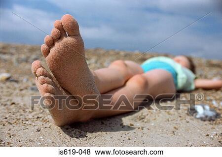 Girl sunbathing on beach View Large Photo Image Stock Photo - Girl sunbathing on beach. Fotosearch