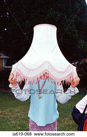 Girl wearing a lampshade View Large Photo Image Stock Photo - Girl wearing a lampshade. Fotosearch