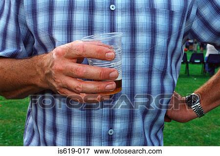 Stock Photo - Man drinking beer in garden. Fotosearch