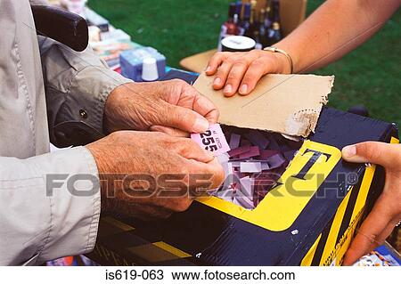 Man holding raffle ticket View Large Photo Image Stock Image - Man holding raffle ticket. Fotosearch