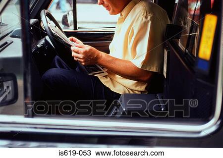 Taxi driver reading a newspaper View Large Photo Image Stock Image - Taxi driver reading a newspaper. Fotosearch