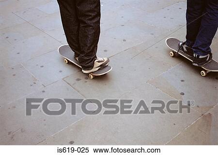 Two boys skateboarding View Large Photo Image Stock Photography - Two boys skateboarding. Fotosearch