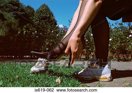 Woman changing shoes in park View Large Photo Image Stock Image - Woman changing shoes in park. Fotosearch