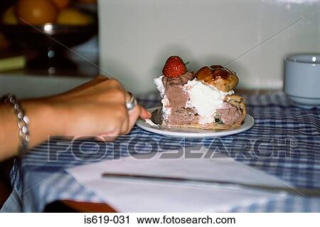 Woman eating a cake in cafe View Large Photo Image Stock Image - Woman eating a cake in cafe. Fotosearch