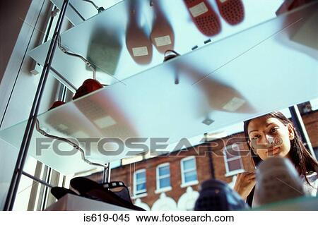 Stock Photography - Woman window shopping for shoes. Fotosearch