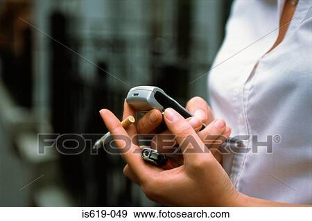Young woman text messaging View Large Photo Image Stock Photo - Young woman text messaging. Fotosearch
