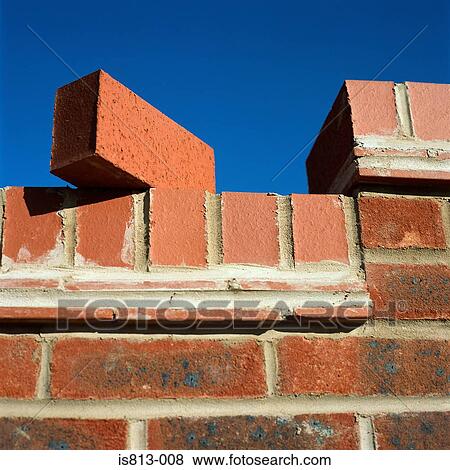 Brick balancing on wall View Large Photo Image Stock Photo - Brick balancing on wall. Fotosearch
