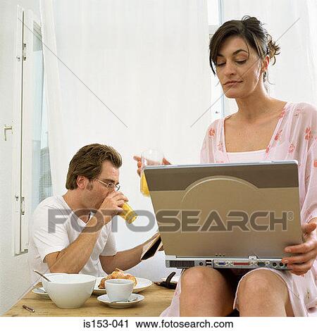 Stock Image - Couple at breakfast with laptop. Fotosearch