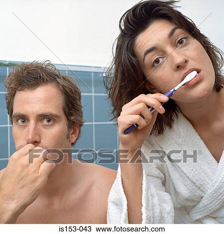 Couple brushing teeth together View Large Photo Image Stock Image - Couple brushing teeth together. Fotosearch