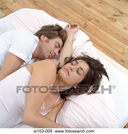Stock Photo - Couple in bed waking up. Fotosearch