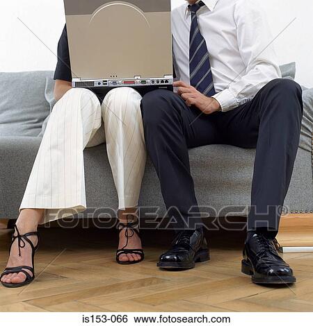 Stock Photograph - Couple sitting with laptop. Fotosearch
