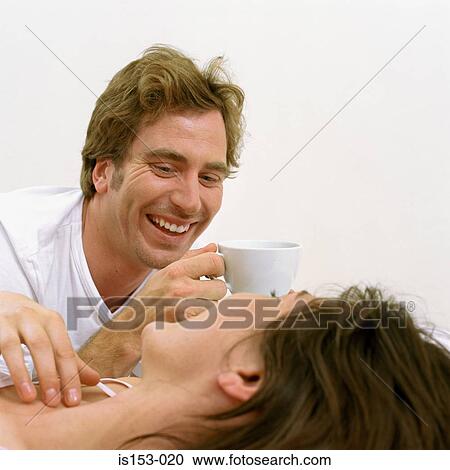 Happy couple awake in bed View Large Photo Image Stock Image - Happy couple awake in bed. Fotosearch