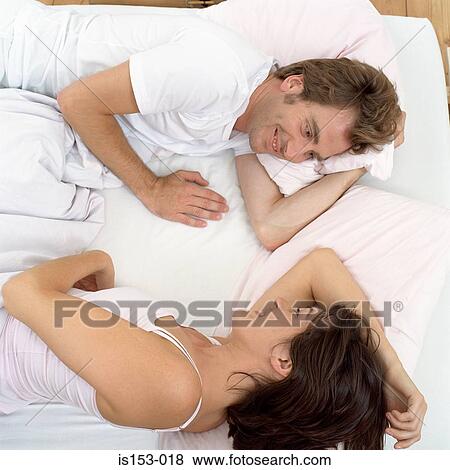 Happy couple awake in bed View Large Photo Image Stock Photo - Happy couple awake in bed. Fotosearch