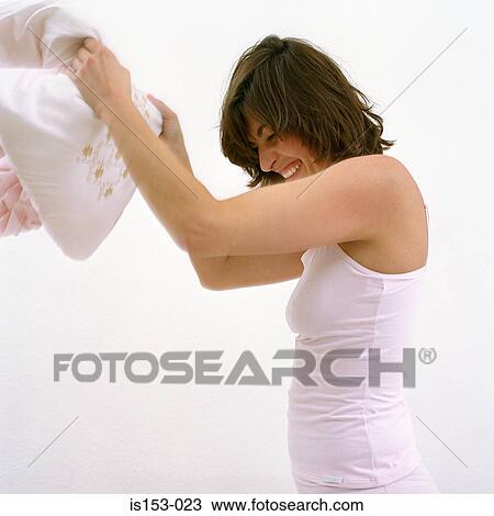 Happy woman in pillow fight View Large Photo Image Stock Image - Happy woman in pillow fight. Fotosearch