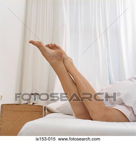 Legs of woman in bed at dawn View Large Photo Image Stock Photography - Legs of woman in bed at dawn. Fotosearch
