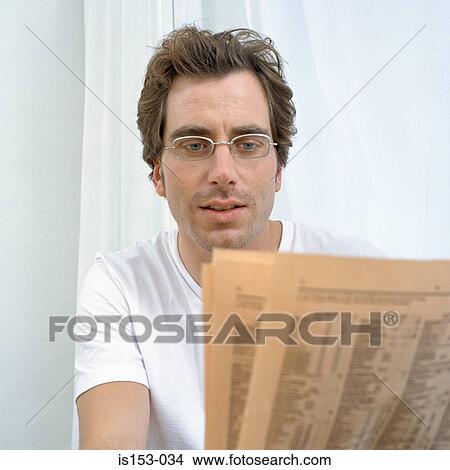 Picture - Man reads financial pages. Fotosearch
