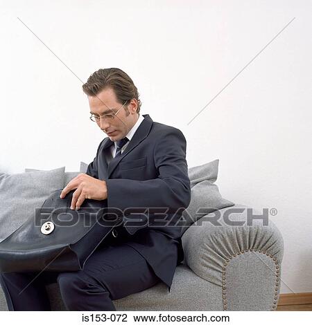 Man searching in his briefcase View Large Photo Image Stock Image - Man searching in his briefcase. Fotosearch
