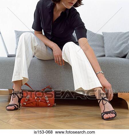 Woman adjusting sandal View Large Photo Image Stock Photo - Woman adjusting sandal. Fotosearch
