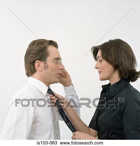 Woman adjusts tie on man View Large Photo Image Stock Image - Woman adjusts tie on man. Fotosearch