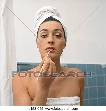 Stock Photography - Woman applying make-up. Fotosearch