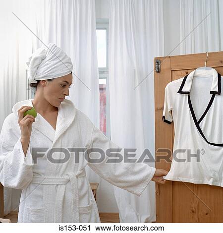 Woman deciding what to wear View Large Photo Image Stock Image - Woman deciding what to wear. Fotosearch