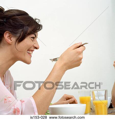 Stock Photo - Woman enjoying breakfast. Fotosearch